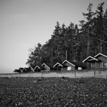 Vintage photo of cabins along pebbled beach