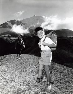 Vintage photograph of kids hiking with backpacks