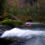 Kayaking through rapids in the Great Outdoors